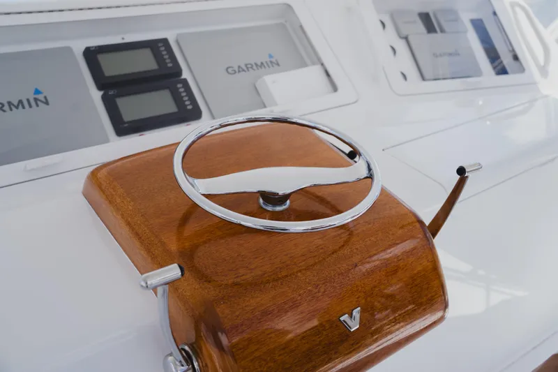 Slide: The Image of Steering wheel of a 1999 Viking 58 Convertible yacht with Garmin navigation displays. - 24