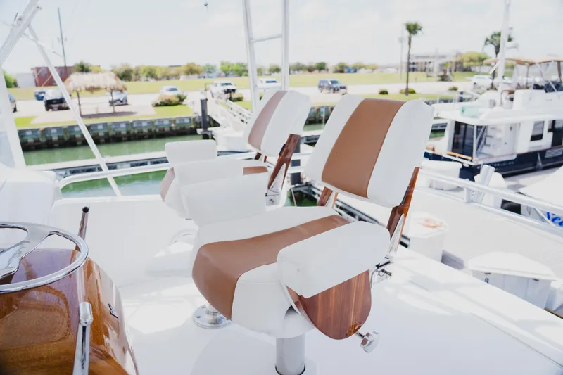 Slide: The Image of Captain's chairs on 1999 Viking 58 Convertible yacht, docked at marina. - 25