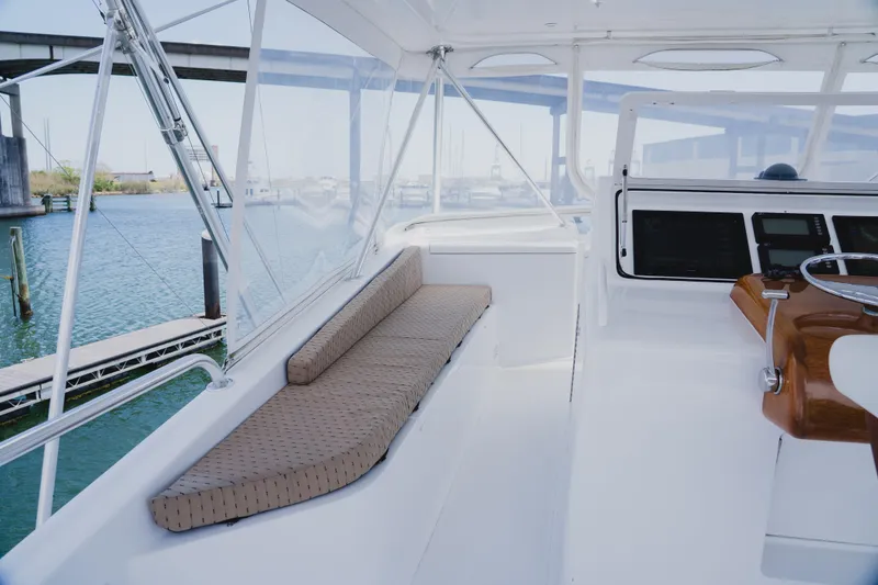 Slide: The Image of 1999 Viking 58 Convertible yacht interior with helm and seating area. - 26