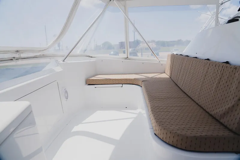 Slide: The Image of Interior view of 1999 Viking 58 Convertible yacht with cushioned seating. - 27