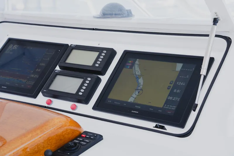 Slide: The Image of Control panel of a 1999 Viking 58 Convertible yacht with navigation screens. - 28
