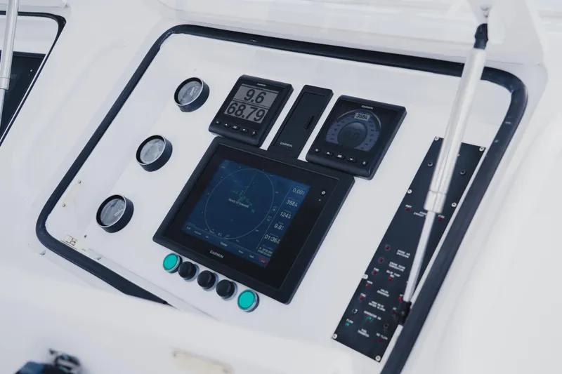 Slide: The Image of Control panel of a 1999 Viking 58 Convertible yacht with navigation instruments. - 29