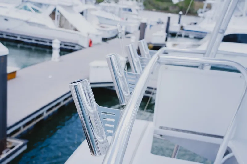 Slide: The Image of Stainless steel rod holders on a 1999 Viking 58 Convertible yacht at a marina. - 32