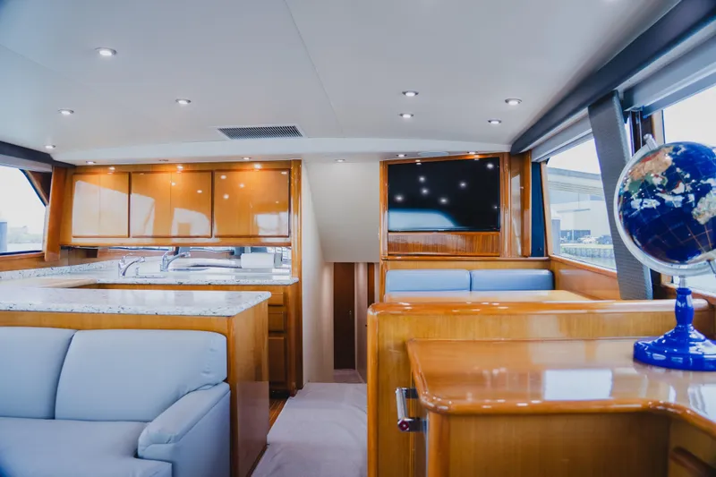 Slide: The Image of Luxurious interior of 1999 Viking 58 Convertible yacht with modern amenities and elegant wood finishes. - 35