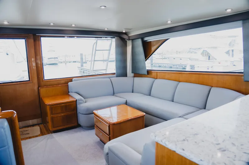 Slide: The Image of Luxurious interior of a 1999 Viking 58 Convertible yacht with plush seating and wooden accents. - 37
