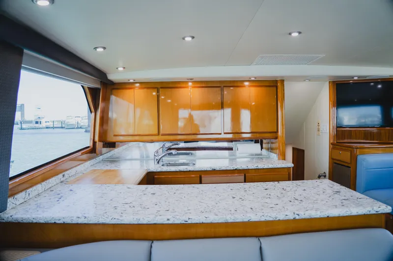 Slide: The Image of Luxurious interior of 1999 Viking 58 Convertible yacht with modern kitchen and granite countertops. - 39