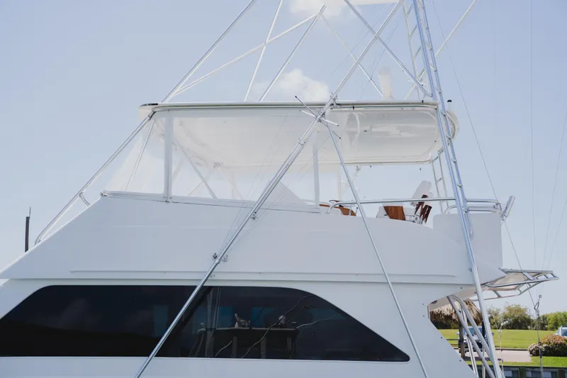 Slide: The Image of 1999 Viking 58 Convertible yacht with sleek design and spacious upper deck. - 4