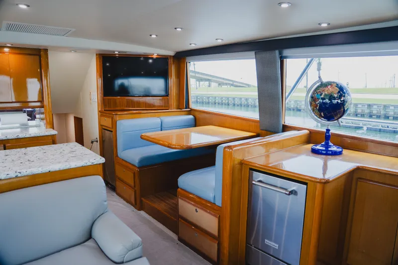 Slide: The Image of Luxurious interior of 1999 Viking 58 Convertible yacht with elegant seating and modern amenities. - 41