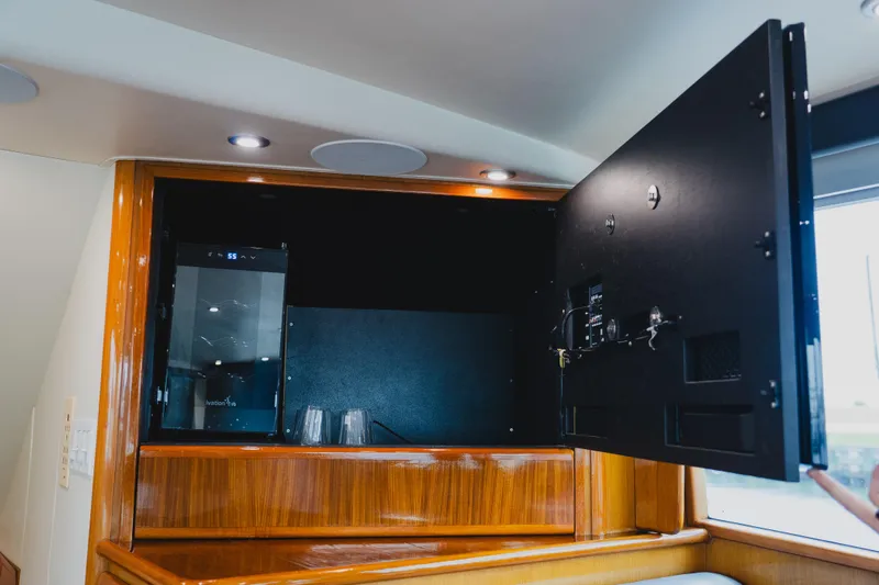 Slide: The Image of 1999 Viking 58 Convertible yacht interior with open cabinet and wine cooler. - 42