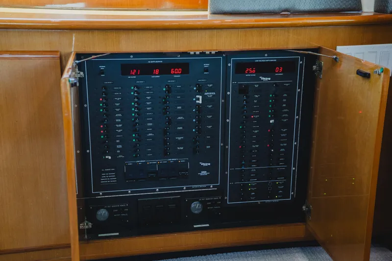 Slide: The Image of Electrical panel inside a 1999 Viking 58 Convertible yacht, showcasing control switches and displays. - 47