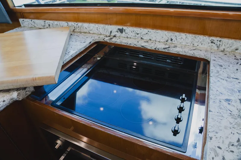 Slide: The Image of Modern kitchen stove on 1999 Viking 58 Convertible yacht with marble countertop. - 51