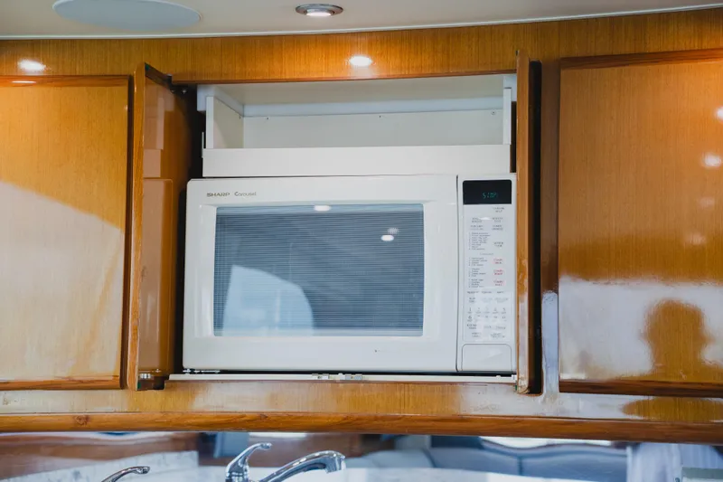 Slide: The Image of Microwave in wooden cabinet on 1999 Viking 58 Convertible yacht kitchen. - 53