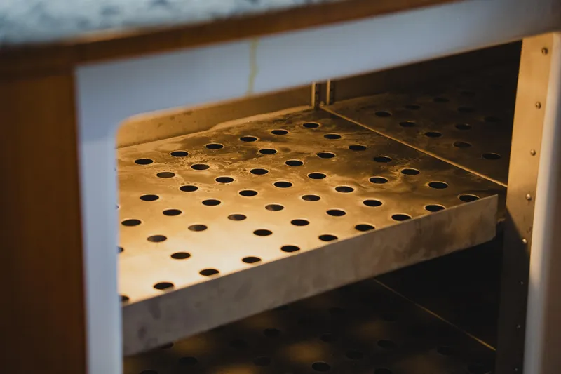 Slide: The Image of Perforated metal shelf inside a 1999 Viking 58 Convertible boat. - 55