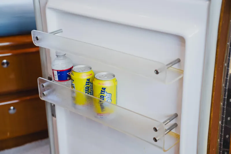 Slide: The Image of Refrigerator door with drinks inside a 1999 Viking 58 Convertible yacht. - 57