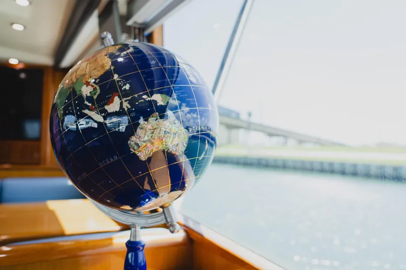 Slide: The Image of Globe inside 1999 Viking 58 Convertible yacht, near window with water view. - 58