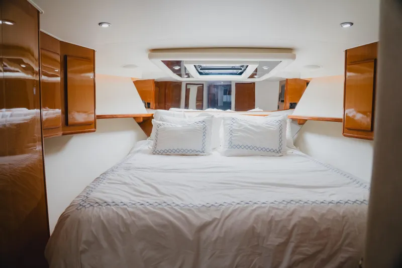 Slide: The Image of Luxurious cabin interior of a 1999 Viking 58 Convertible yacht with elegant bedding. - 60