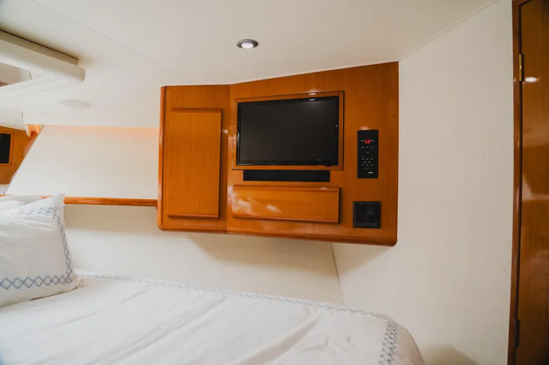Slide: The Image of Interior of 1999 Viking 58 Convertible yacht with TV and wooden cabinetry. - 61