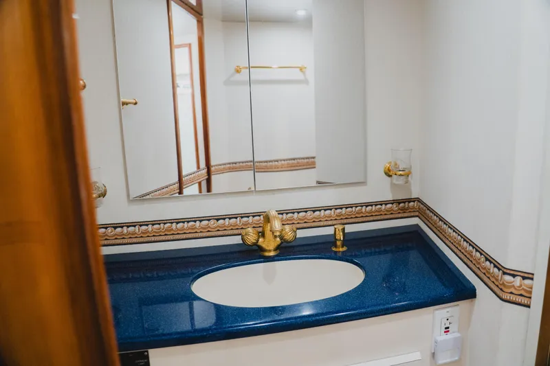 Slide: The Image of Luxurious bathroom vanity with blue countertop in 1999 Viking 58 Convertible yacht. - 63