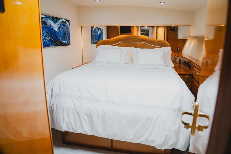 Slide: The Image of Luxurious bedroom interior of 1999 Viking 58 Convertible yacht with elegant bedding. - 66
