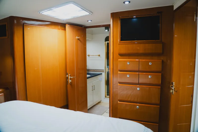Slide: The Image of Luxurious interior of a 1999 Viking 58 Convertible yacht with wood cabinetry and modern amenities. - 67