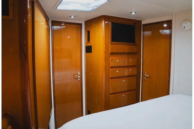 Slide: The Image of Interior of 1999 Viking 58 Convertible yacht with wooden cabinetry and modern lighting. - 68