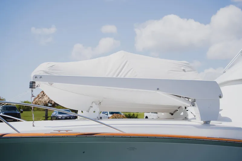 Slide: The Image of Covered boat on 1999 Viking 58 Convertible yacht under a clear blue sky. - 7