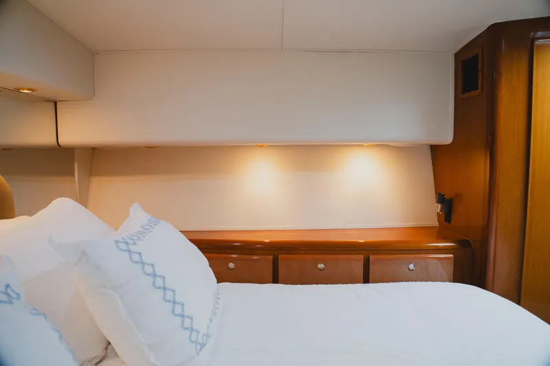 Slide: The Image of Luxurious bedroom interior of a 1999 Viking 58 Convertible yacht with elegant wood finishes. - 70