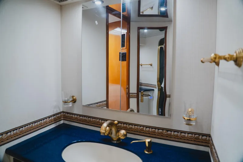 Slide: The Image of Luxurious bathroom interior of a 1999 Viking 58 Convertible yacht with elegant fixtures. - 72