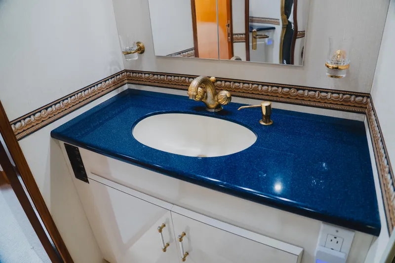 Slide: The Image of Luxurious bathroom sink with blue countertop in 1999 Viking 58 Convertible yacht. - 73