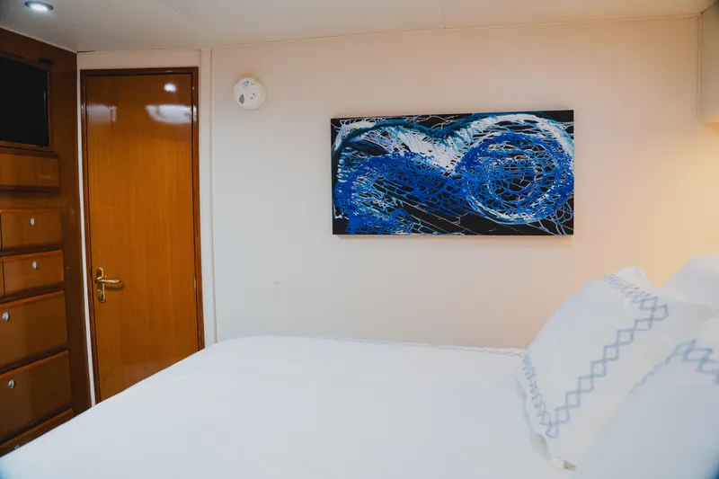 Slide: The Image of Interior of 1999 Viking 58 Convertible yacht with abstract blue artwork. - 77