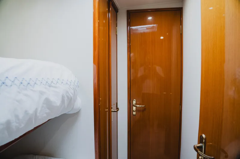 Slide: The Image of Interior of 1999 Viking 58 Convertible yacht with wooden doors and bunk bed. - 81