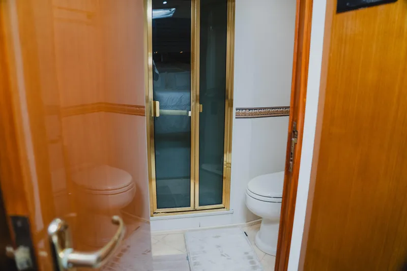 Slide: The Image of Bathroom interior of a 1999 Viking 58 Convertible yacht with shower and toilet. - 82