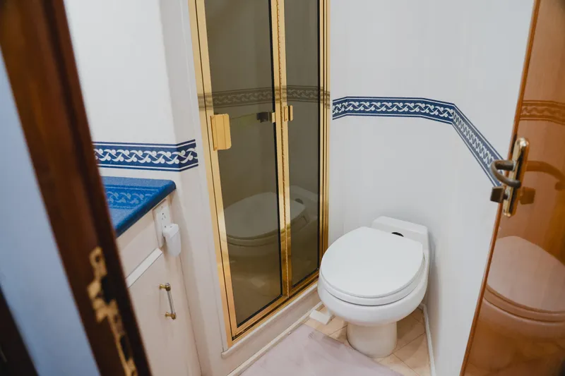 Slide: The Image of Bathroom interior of 1999 Viking 58 Convertible yacht with shower and toilet. - 85