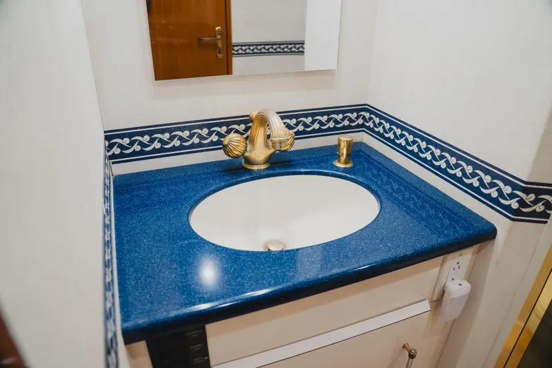 Slide: The Image of Luxurious blue countertop with gold faucet in 1999 Viking 58 Convertible yacht bathroom. - 86