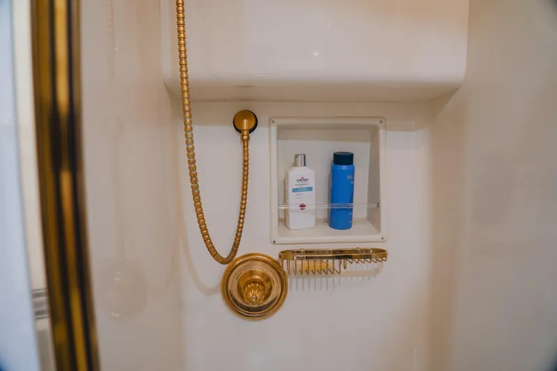 Slide: The Image of Luxury shower with gold fixtures on 1999 Viking 58 Convertible yacht. - 87