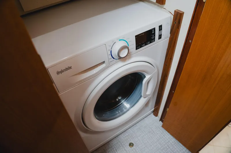 Slide: The Image of Splendide washing machine inside a 1999 Viking 58 Convertible yacht's laundry area. - 88