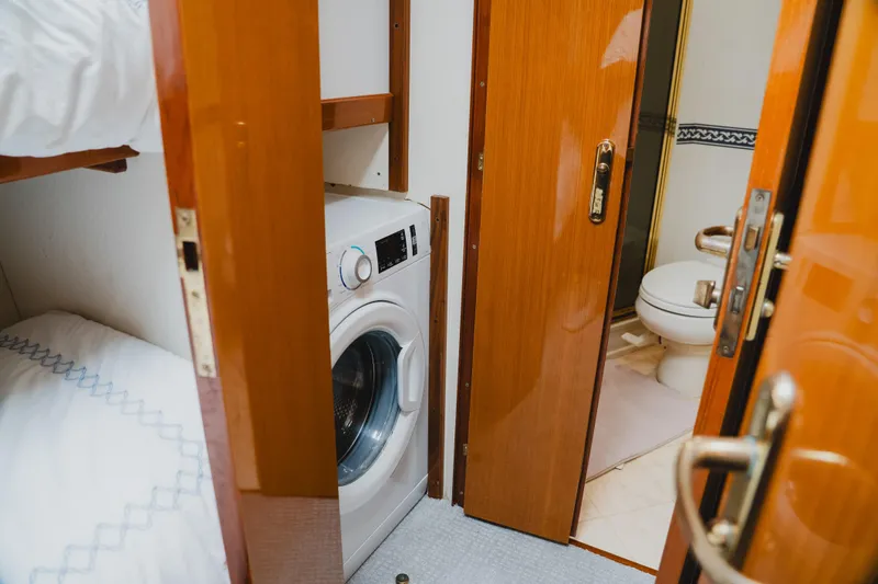Slide: The Image of Laundry area and bathroom inside 1999 Viking 58 Convertible yacht. - 89