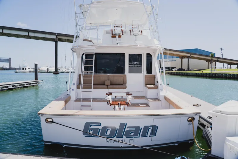 Slide: The Image of 1999 Viking 58 Convertible yacht docked in a marina, rear view. - 9
