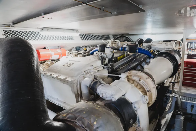Slide: The Image of Engine room of a 1999 Viking 58 Convertible yacht, showcasing machinery and components. - 95