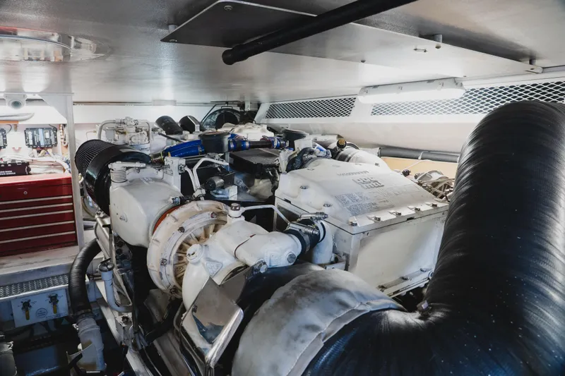 Slide: The Image of Engine room of a 1999 Viking 58 Convertible yacht, showcasing machinery and components. - 96