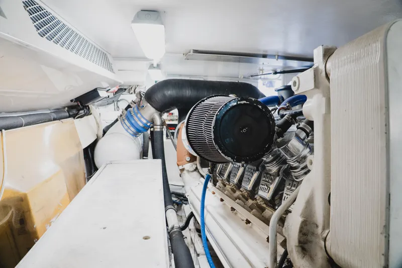 Slide: The Image of Engine room of a 1999 Viking 58 Convertible yacht, showcasing detailed machinery components. - 97
