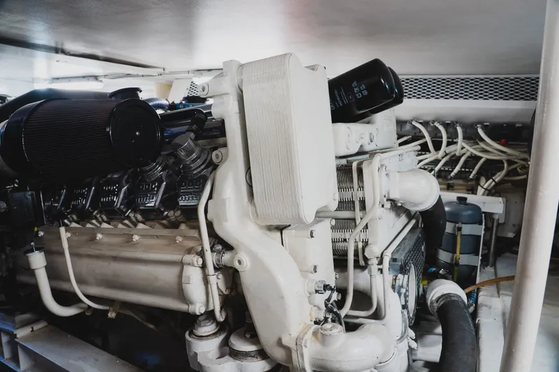 Slide: The Image of Engine room of a 1999 Viking 58 Convertible yacht, showcasing detailed machinery. - 99