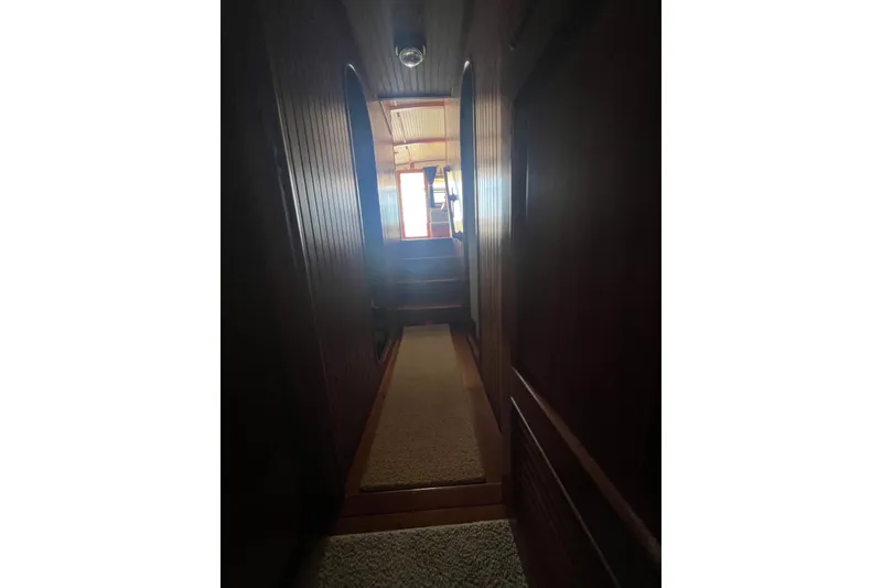 Slide: The Image of 1989 Hans Christian INDEPENDENCE 45 TRAWLER bathroom with wooden cabinets and storage shelves. - 127