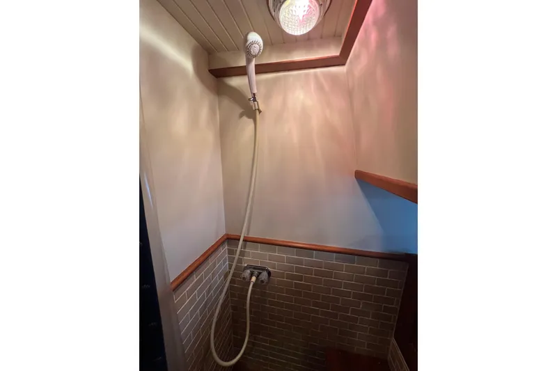 Slide: The Image of Tank tender gauge on 1989 Hans Christian INDEPENDENCE 45 TRAWLER, wooden panel background. - 136