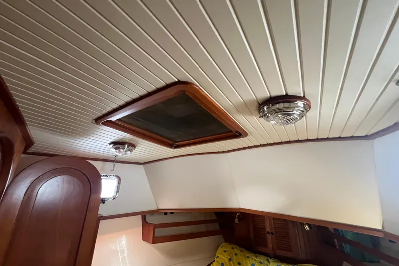 Slide: The Image of Engine room of 1989 Hans Christian INDEPENDENCE 45 TRAWLER with mechanical components and wiring. - 145