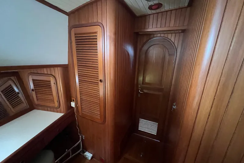 Slide: The Image of Engine room of 1989 Hans Christian INDEPENDENCE 45 TRAWLER with visible components and hoses. - 149