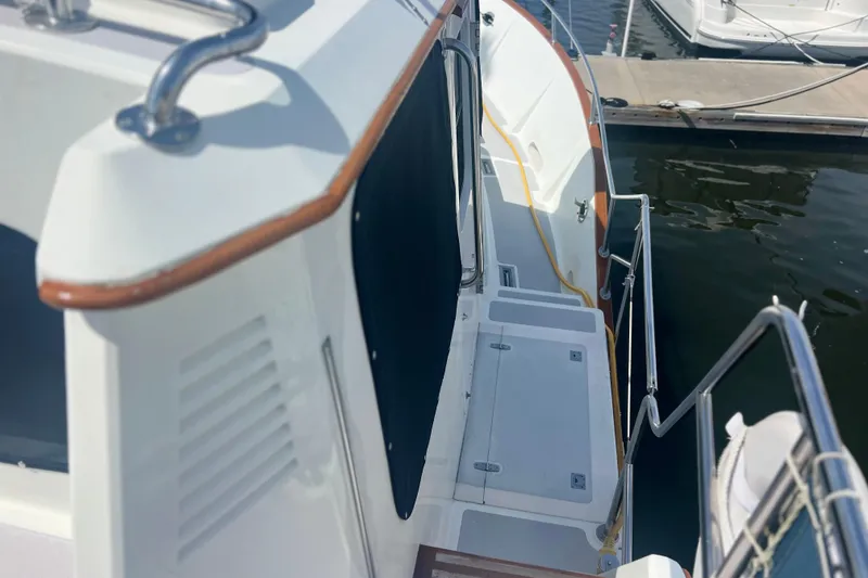 Slide: The Image of 1989 Hans Christian INDEPENDENCE 45 TRAWLER deck with steps and railing by the water. - 18