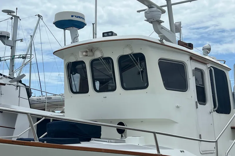 Slide: The Image of Radar and communication equipment on a 1989 Hans Christian INDEPENDENCE 45 TRAWLER against a marina backdrop. - 29
