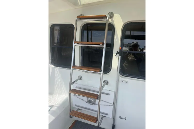 Slide: The Image of 1989 Hans Christian INDEPENDENCE 45 TRAWLER docked, featuring enclosed cockpit and scenic waterfront view. - 35