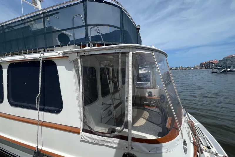 Slide: The Image of Engine room of 1989 Hans Christian INDEPENDENCE 45 TRAWLER with mechanical components and storage crate. - 48
